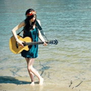 美女拿着吉他在大海的